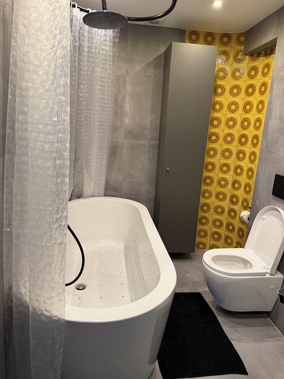A bathroom with a bathtub, toilet, and shower.