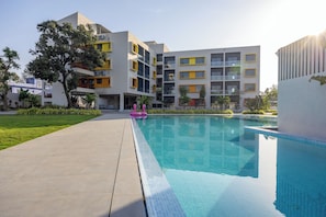Enjoy a refreshing dip in the pool surrounded by lush greenery and expansive views.