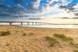 A beach with a long bridge in the background. - "GEMÜTLICH" Apartment (50 m²), air-conditioned, Wi-Fi—ideally located—private parking, Netflix (Lagord)