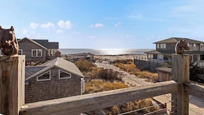 A coastal property with a wooden fence, beach access, and houses with horse statues. - Gatsby’s Sky Level. Ocean Bay Park. 
Sleeps 12. Hot Tub + Ocean Views (Fire Island)