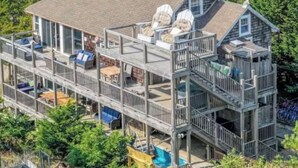 A multi-story house with a balcony, a deck, and a pool. - Gatsby’s Sky Level. Ocean Bay Park. 
Sleeps 12. Hot Tub + Ocean Views (Fire Island)