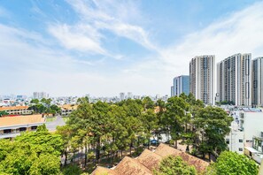 A cityscape with high-rise buildings, a park with trees, and a road. - Townhouse Cuong Thanh 3 Hotel (Ho Chi Minh City)