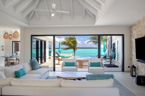 Relax in this spacious living room with a sofa, flat-screen TV, and dining area.