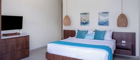 A modern bedroom with a large bed, wooden nightstands, a flat-screen TV, and two wall-mounted artworks.