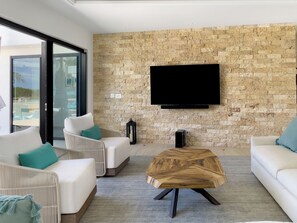 Relax in style with a large flat-screen TV, comfortable seating, and a unique coffee table.