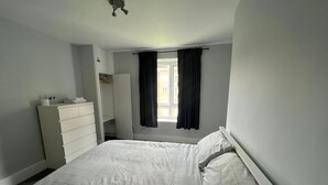 A bedroom with a bed, a dresser, and a wardrobe. - Vauxhall Central Room 3 (Greater London)