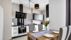 A modern kitchen with a dining area.