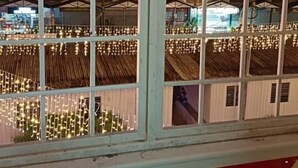 A view through a window with a grid pattern, displaying a building with multiple floors and a balcony area. - cool memories hotel  (Tanah Rata)