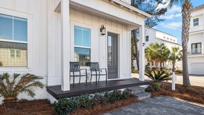 A two-story house with a covered porch, a front door, and a mailbox. - 🦩Book Me Baby! Seas The Day at Inlet Beach🦩 (Inlet Beach)