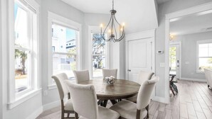 A dining room with a round table, six chairs, and a chandelier. - 🦩Book Me Baby! Seas The Day at Inlet Beach🦩 (Inlet Beach)