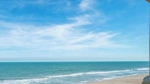 A beach with clear skies and calm water. - Oceanfront I Resort-Style I Heated Pool I Beach (Cape Canaveral)