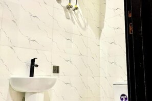 Shower, towels, soap, toilet paper
