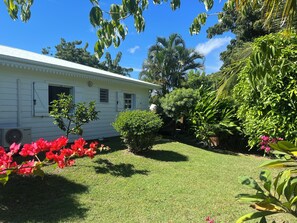 Guests can enjoy a serene garden with a covered porch and seating area.