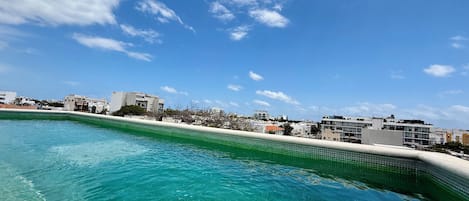 Una piscina al aire libre, sombrillas