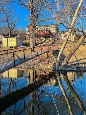 Cross a tranquil bridge to a serene lakeside retreat.