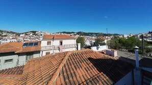 A residential area with terracotta-tiled rooftops and white buildings. - Nel Paese Room (Skiathos)