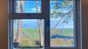 A window with a view of a rural landscape, including trees and fields. - 2 Bed Chalet with Rural Views (Dartmouth)