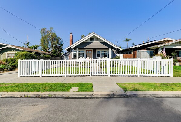 A residential house with a front yard, white picket fence, and a clear sky. - San Diego Historic Craftsman: Near Zoo and Balboa Park! (San Diego)