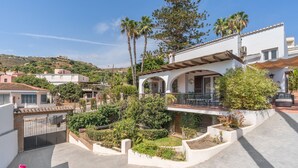 A residential property with a patio, garden, and a view of the surrounding neighborhood.