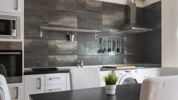 A modern kitchen with a microwave, oven, and stainless steel range hood.