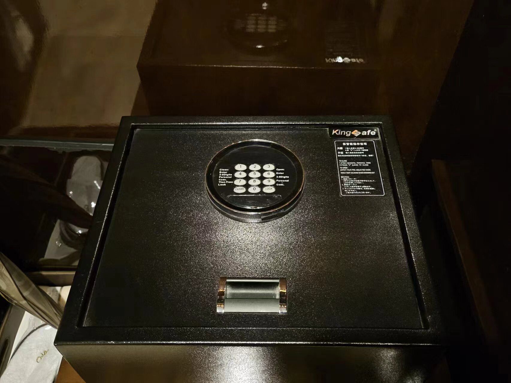 A black safe with a keypad and a lock mechanism.