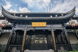 A traditional Chinese building with ornate black doors and a curved roof.