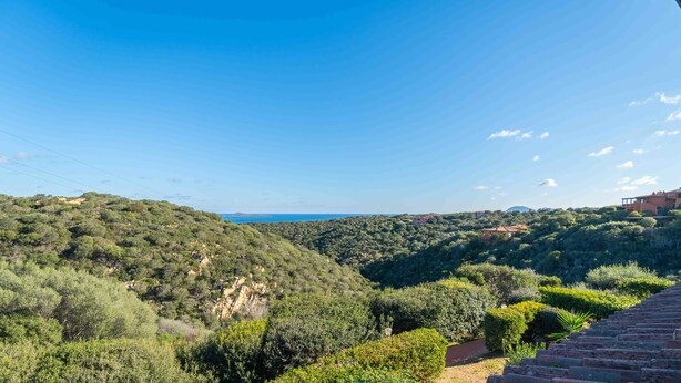 A hillside view with a pathway leading to a building with a red roof. - Sea & Tranquility - with Wi-Fi and sea view (Olbia)