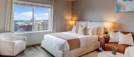 Relax in this stylish room with a large bed, bedside tables, and a city view.