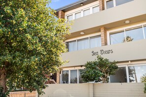 Experience the charm of Sea Views, a two-story building with a modern design and large windows offering a glimpse into its interior.