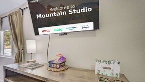 A hotel reception desk with a flat-screen TV displaying a welcome message and streaming service logos. - Mountain Studio! Cozy Escape with Stunning Views (Cascade-Chipita Park)