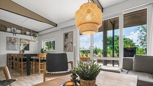 A modern living room with a wooden coffee table, a woven pendant light, and a view of the outdoors. - "Fatima" - 1km from the sea by Interhome (Fanø)