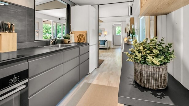 A modern kitchen with a large island, dark cabinetry, and a large mirror. - "Fatima" - 1km from the sea by Interhome (Fanø)