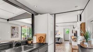 A modern kitchen with a large island, stainless steel sink, and wooden cutting board. - "Fatima" - 1km from the sea by Interhome (Fanø)