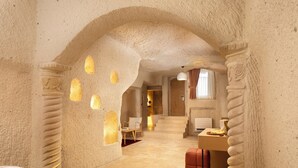 A room with a unique textured ceiling, a bed, a desk, and a chair.
