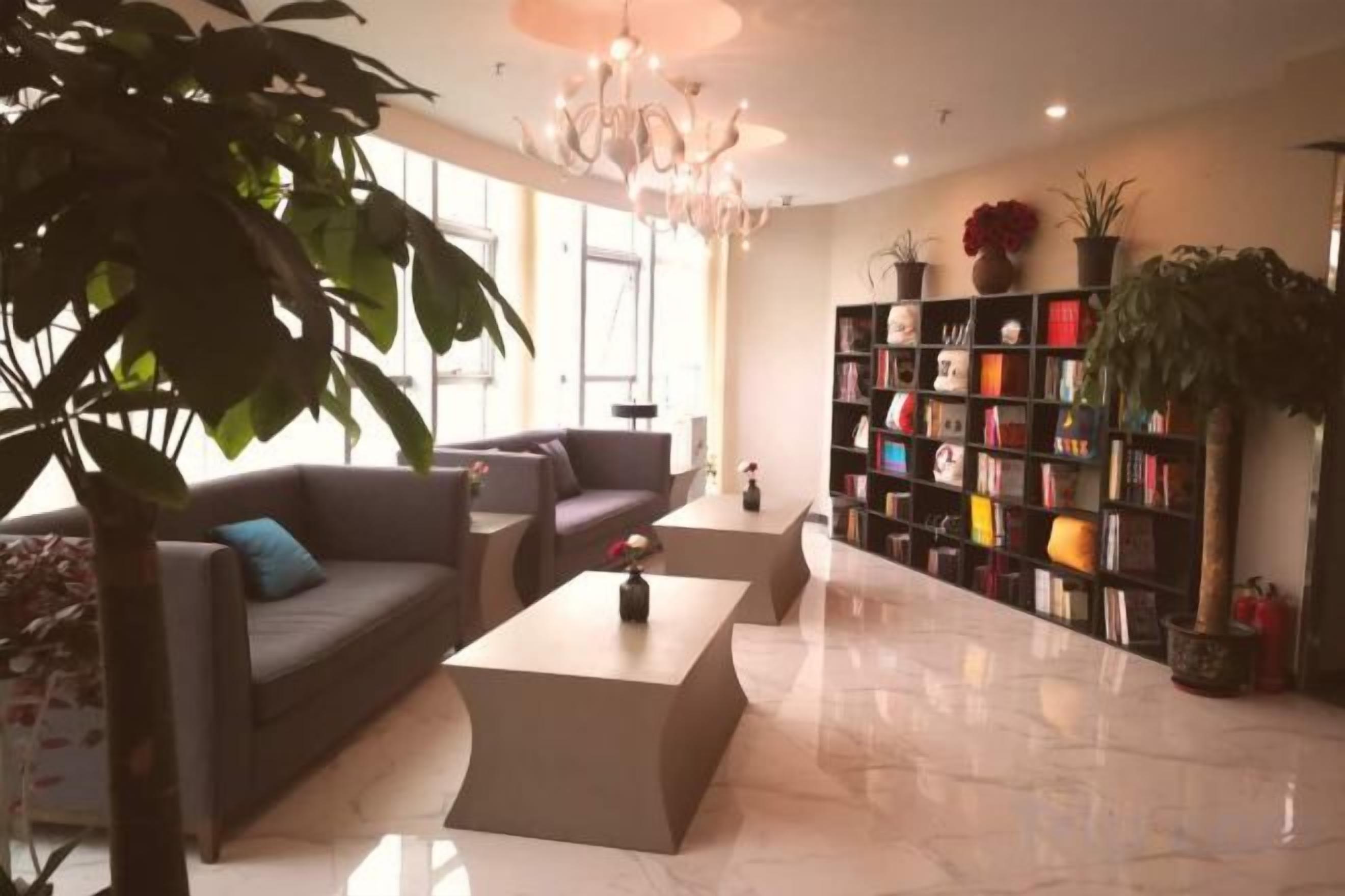 A modern living room with a sofa, coffee table, and a bookshelf.