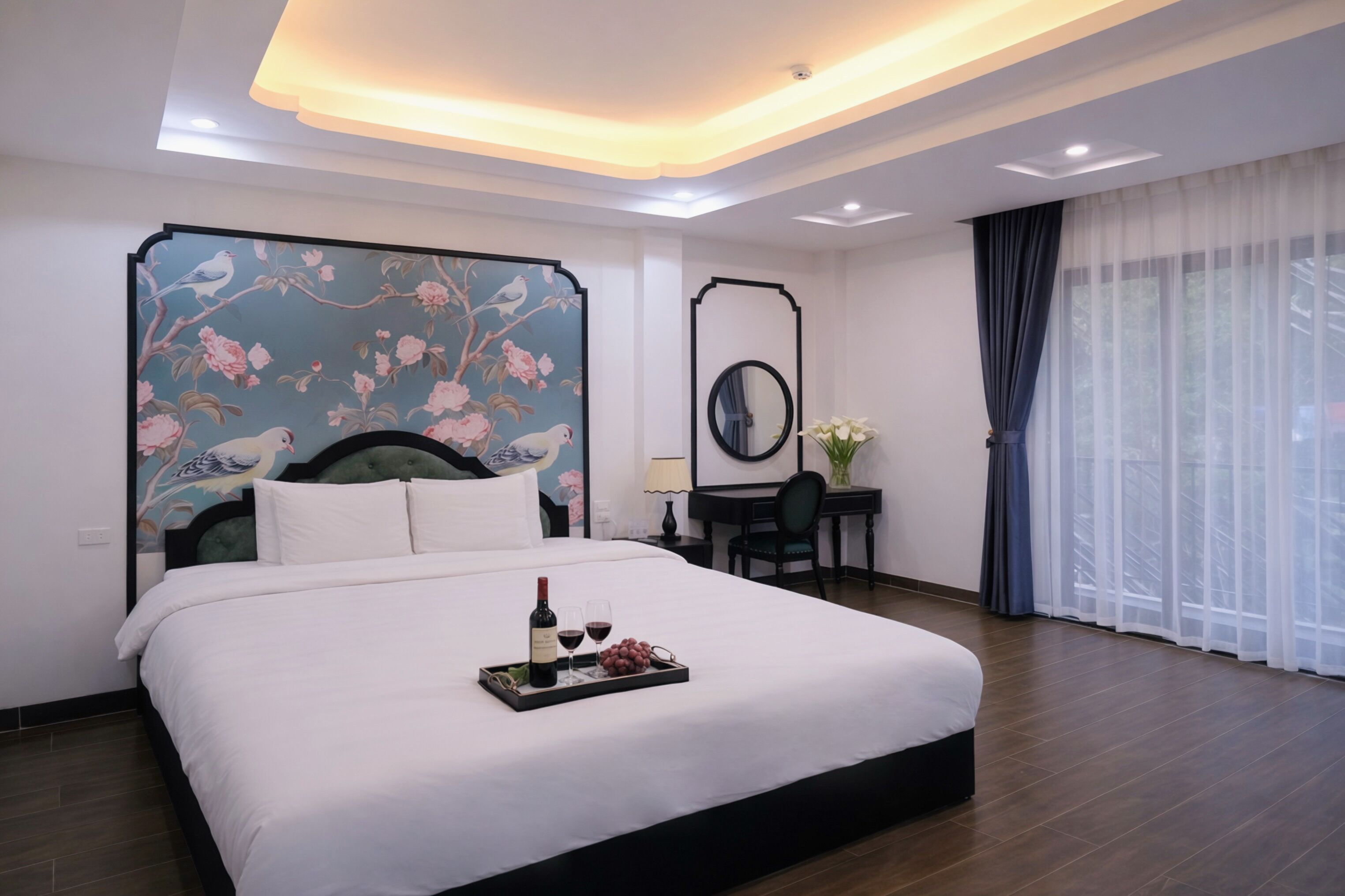 A hotel room with a large bed, a desk, a chair, a mirror, and a window with curtains.