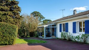 A house with a covered porch, a garden, and a clear sky. - La Bruyère by Interhome (La Bernerie-en Retz)