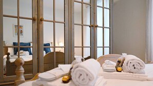 A hotel room with a bed, a wooden headboard, and a large mirror reflecting the room. - Ruga Vacation Rental 3 in Ascona (Ascona)