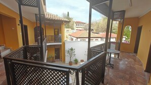A multi-level balcony with a view of neighboring buildings.