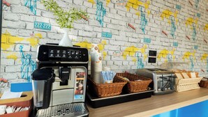 A coffee station with a coffee machine, baskets, and a toaster on a counter.