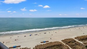 A beach with a clear sky, calm sea, and sandy shore. - Panoramic Ocean View, Lazy River (North Myrtle Beach)