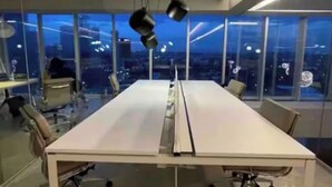 A modern conference room with a long table, chairs, and pendant lighting. - Apartment in plaza pabellon zone andares (Guadalajara)