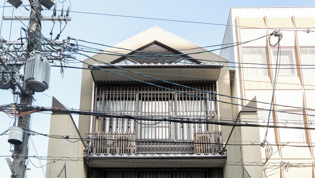 A multi-story residential building with a central balcony, a garage, and a small driveway. - Hotel SaintFelician Kyoto Shijo Karasuma (Kyoto)