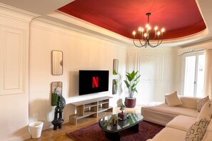Basic Apartment | Living area | 55-inch TV with satellite channels - Xuru Stays I The 2bdr Crimson Crib @ The Heart Of Heliopolis (Cairo)