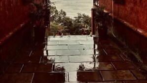 A pathway leading to a house with a view of a body of water and mountains. - Waves and Vibes Resort (Pune)