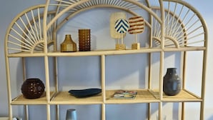 A multi-tiered, open shelving unit with various decorative items and a small lamp. - 5 DTV star vacation apartment on Lake Stella with marina view (Bad Zwischenahn)