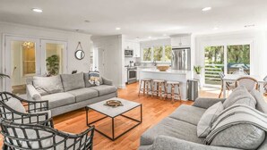 A modern living room with a grey sofa, a coffee table, and wicker chairs. - 374 Perch Drive (Fripp Island)
