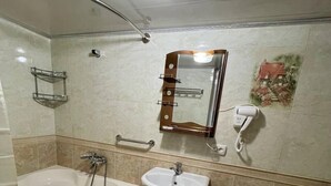 A bathroom with a bathtub, sink, and toilet. - Sweet Home (Samarkand)