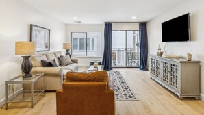 Ein modernes Wohnzimmer mit Sofa, Couchtisch und Fernseher.