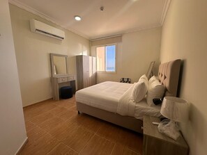 Enjoy a restful night's sleep in this spacious bedroom with a large bed and a window offering a view of the outdoors.